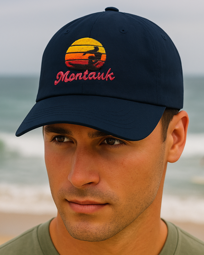 Man wearing a cap with 'Montauk' on a beach